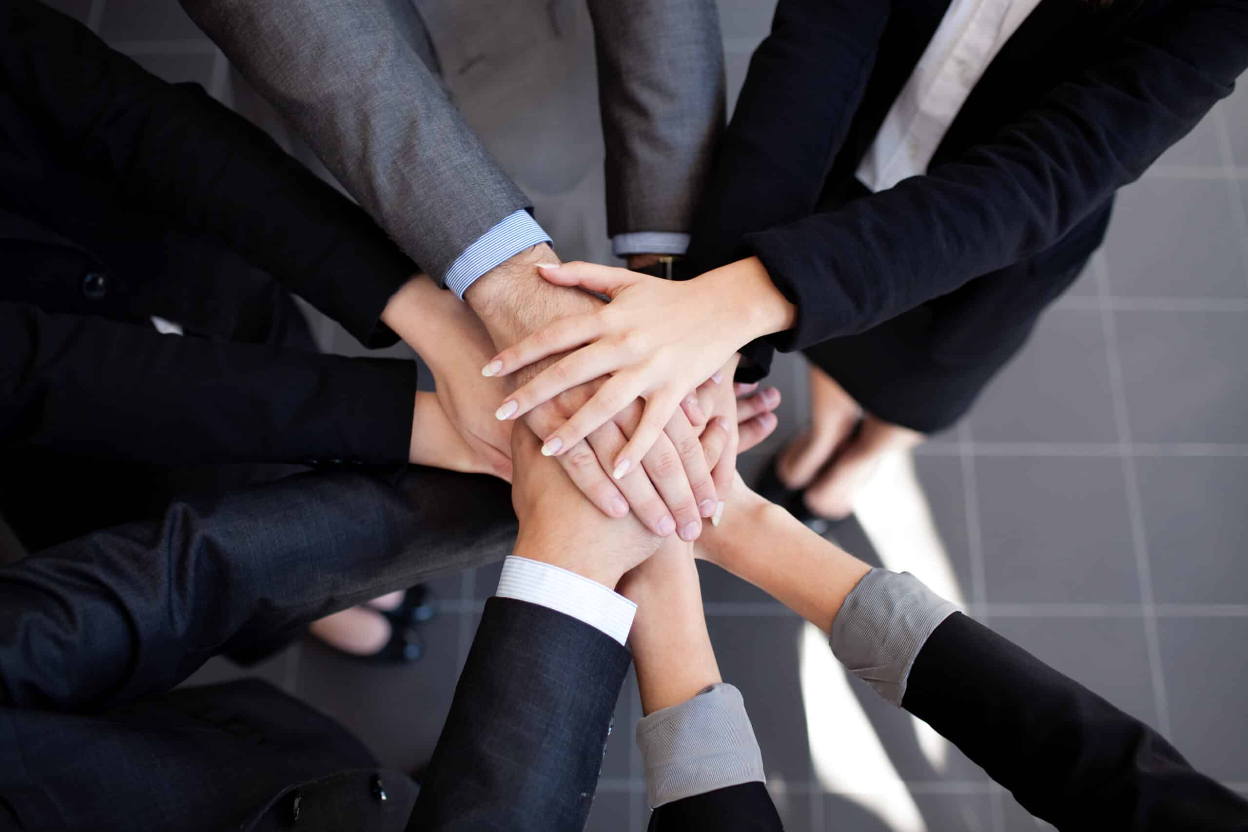 Team work concept. Business people joining hands.